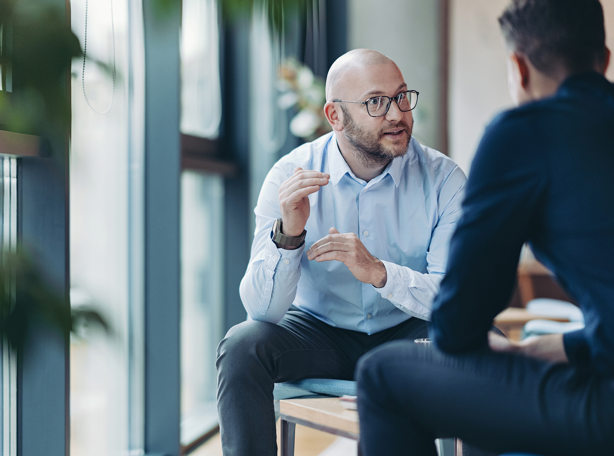 Centralized leasing operations image showing two people dscussing work